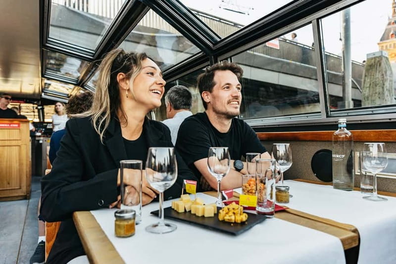 Amsterdam: Cozy Cheese & Wine Cruise Tasting Experience - Dutch cheese, salty snacks, and a full glass