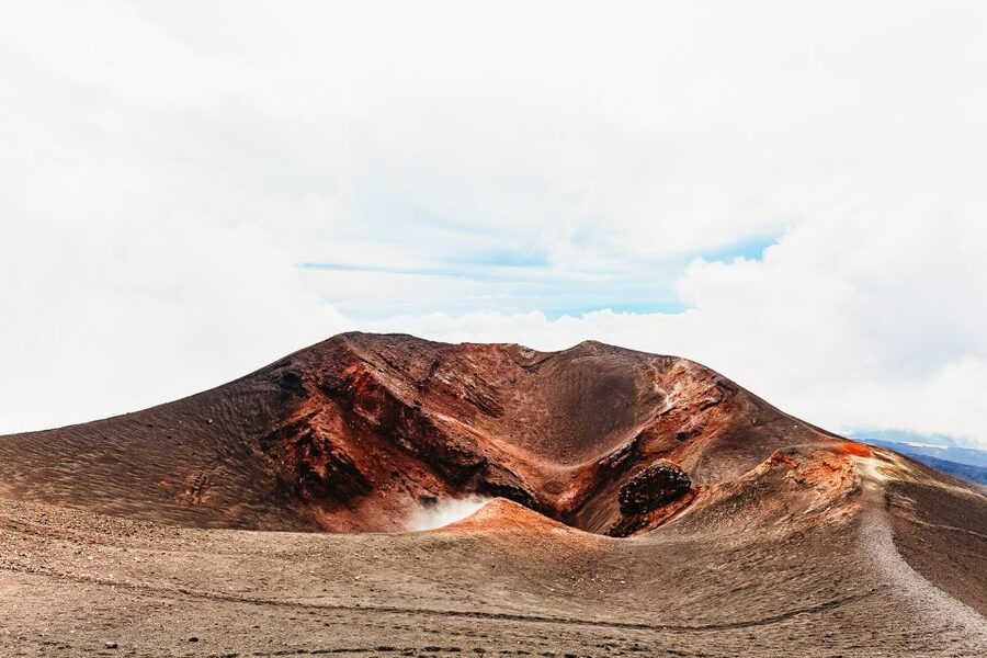 From Catania: Mt. Etna, Wine and Alcantara Tour - Entering a lava cave with a helmet and lamp