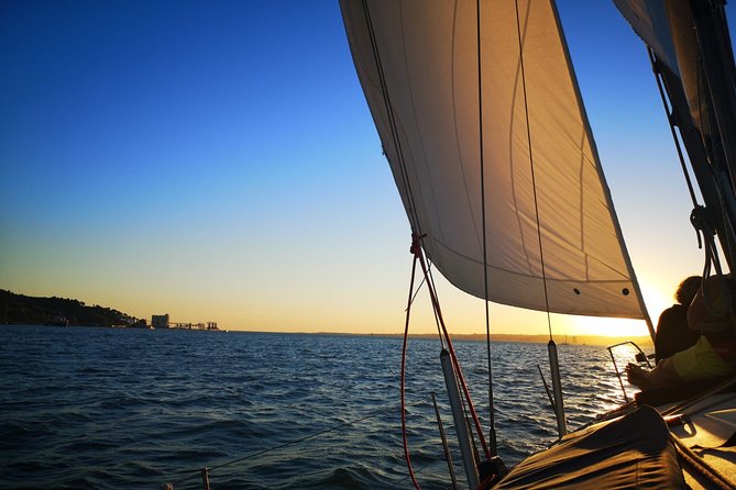 Lisbon: Sunset Sailing with Portuguese Wine and History - Under the bridge and toward Commerce Square