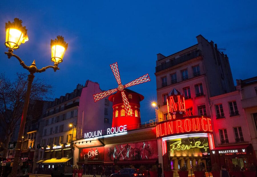 Paris: Moulin Rouge Show with Champagne and Drop-Off Service - Inside Féerie: feathers, rhinestones, and a very large cast
